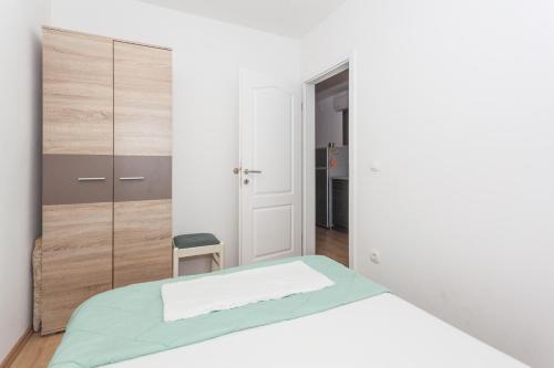 a bedroom with a bed and a closet at Apartment Dome in Biograd na Moru