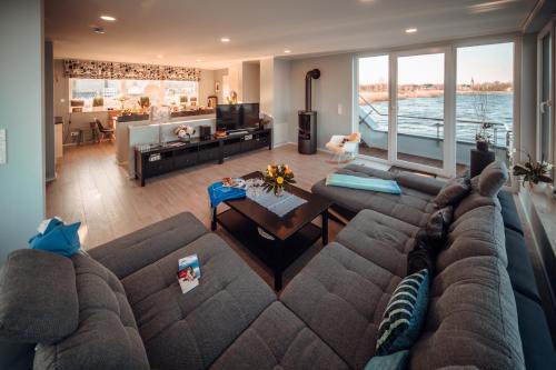 a living room with a large couch and a table at Goitzsche Resort in Bitterfeld