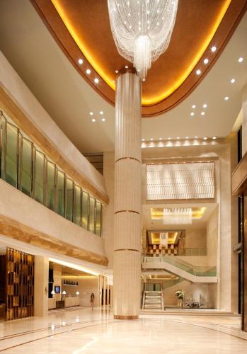 a lobby of a hotel with a chandelier at Radisson Blu Plaza Chongqing - Free one cup of smoky the gelnlivet during stay in Chongqing