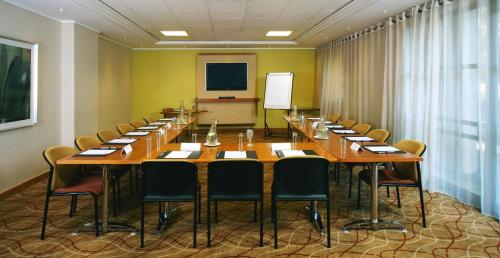 a large conference room with a long table and chairs at Garden Court Eastgate in Johannesburg
