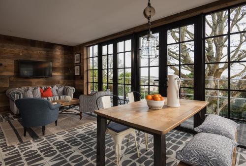 a living room with a table and some chairs at Merchants Manor Spa in Falmouth