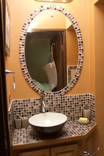 a bathroom with a sink and a mirror at One32 Guesthouse Red Velvet in Kingston