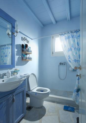 a bathroom with a toilet and a sink and a shower at Villa Celestia in Ornos