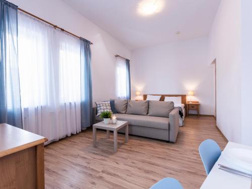a living room with a couch and a table at VacationClub - Olymp Apartment 503 in Kołobrzeg