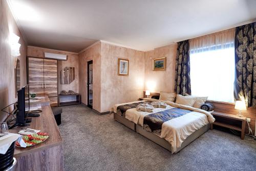 Postel nebo postele na pokoji v ubytování Platinum Image Hotel