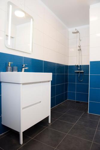 a bathroom with a white sink and a mirror at Media Luna Guesthouse in Seyðisfjörður