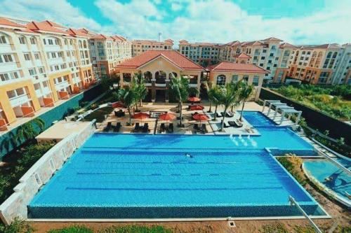 an overhead view of a swimming pool at a resort at Two-Bedroom at San Remo Oasis in Cebu City