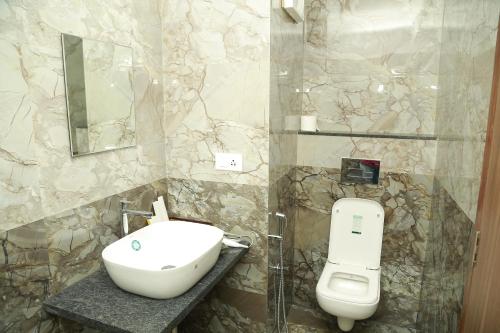 a bathroom with a sink and a toilet at Silicon Inn Hotel Bangalore Airport in Devanahalli-Bangalore