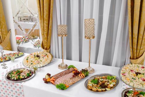 a table with many plates of food on it at Dworek Vesaria in Lublin