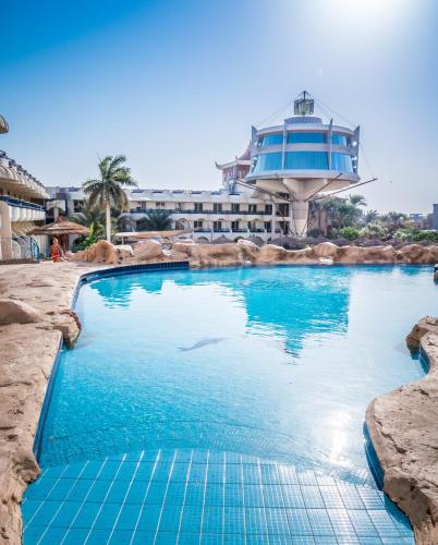 a large swimming pool with a building in the background at Seagull Beach Resort - Families and Couples Only in Hurghada