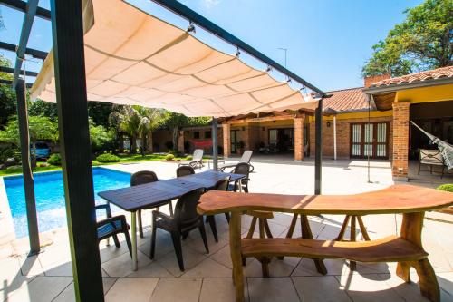 a patio with a table and chairs and a pool at Casa Berni Beach in San Bernardino