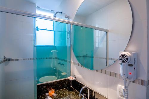 a bathroom with a shower, sink, and toilet at Argentina Hotel in Rio de Janeiro