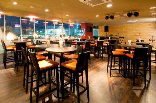 a restaurant with tables and chairs in a room at Hotel Granada Johor Bahru in Johor Bahru