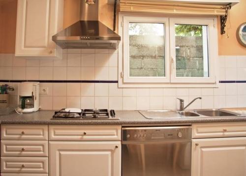 a kitchen with a sink and a stove at Gite les Flots Bleus in Jullouville-les-Pins