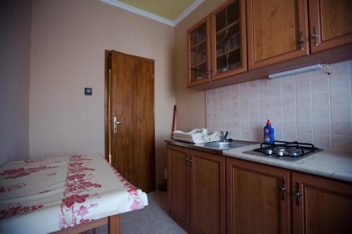 a kitchen with a sink and a counter top at Adonisz Vendégház in Mórahalom