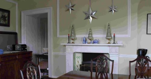 a living room with a fireplace with stars on the wall at Bank House B and B in Penrith