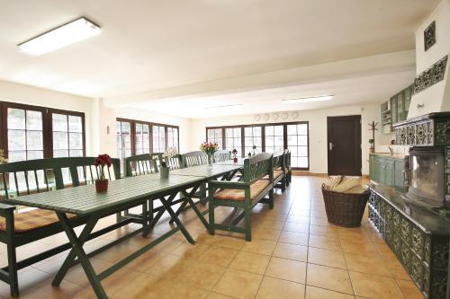 a large dining room with a long table and benches at Apartmány Dolní Moravice in Dolní Moravice
