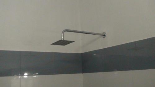 a bathroom with a shower with a light on the ceiling at Takashi Homestay North Paravur Near Muziris in North Paravur