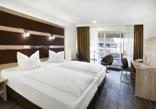 Postel nebo postele na pokoji v ubytování Roomingtons Kaiserhof Landshut