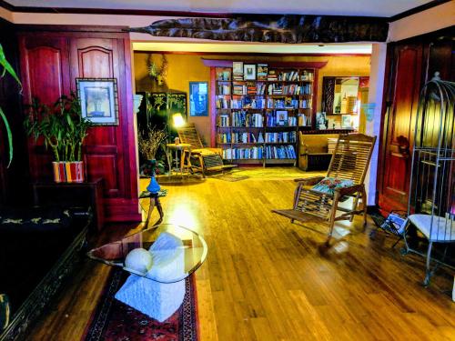 a living room with a couch and a table and chairs at Chelsea Pub and Inn in Atlantic City