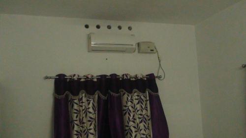 a room with a curtain and a curtain rod with a window at Takashi Homestay North Paravur Near Muziris in North Paravur