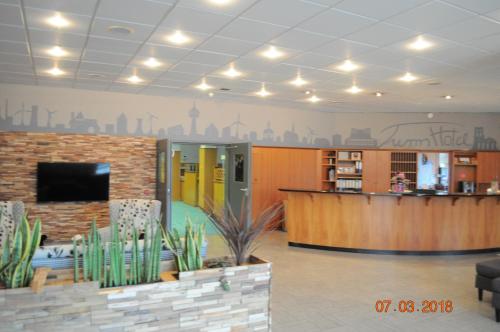 a lobby with a reception area and a library at Turmhotel Schwedt in Schwedt