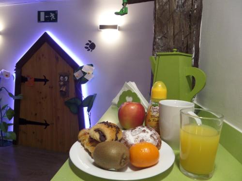 a table with a plate of food and a drink at Pensión AliciaZzz Bed And Breakfast Bilbao in Bilbao