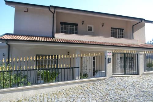a house with a gate in front of it at Vila Teixeira in Amarante
