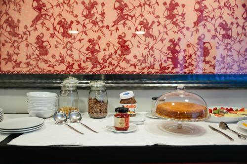 a table with a plate of food on a table at Hotel Rural Misarela in Geres