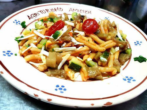 a plate of food with pasta and vegetables at Agriturismo Amicizia in Cassano delle Murge