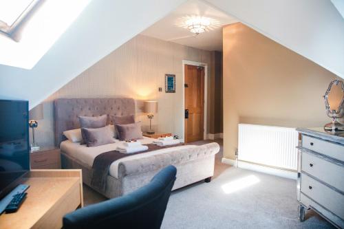 a bedroom with a bed and a couch in a room at Washington House Hotel in Bournemouth
