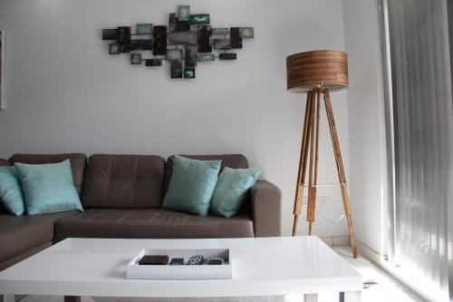 a living room with a couch and a table at Marsascala Interlace Apartment with free parking in Marsaskala