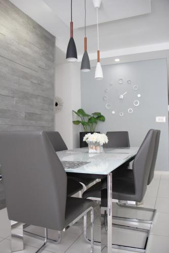 a dining room with a table and chairs at Marsascala Interlace Apartment with free parking in Marsaskala