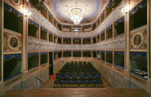 an empty auditorium with chairs and a ceiling at B&B Molino Del Gobbo in SantʼAgata Feltria