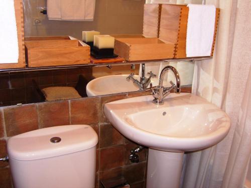 a bathroom with a toilet and a sink at Estrela Park in Lisbon