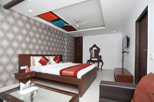 a bedroom with a bed and a sink in a room at Hotel Flora Inn in Gurgaon