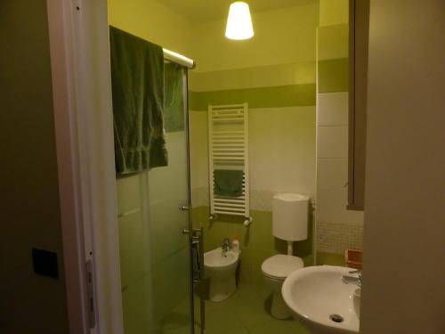 a bathroom with a sink and a toilet and a shower at Casa dei Nonni in Pianezza