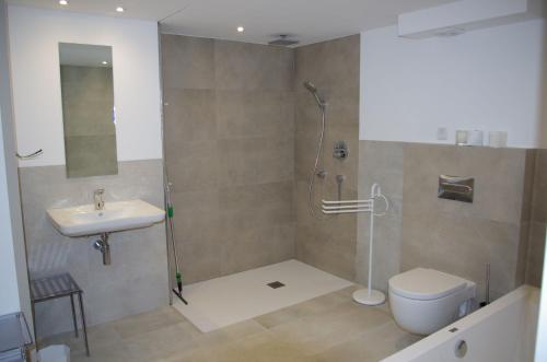 a bathroom with a shower and a toilet and a sink at Eden Playa Standing in Sant Antoni de Calonge