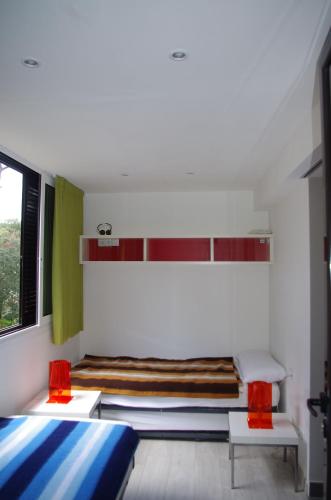 a bedroom with two beds and a window at Eden Playa Standing in Sant Antoni de Calonge