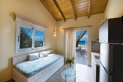 a bedroom with a bed and a balcony with the ocean at Makis&Fani Homes in Lefkada Town