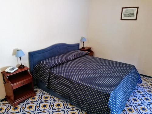 a bedroom with a bed and a dresser at La Taverna del Leone in Positano