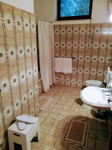 a bathroom with a sink and a toilet at La Taverna del Leone in Positano