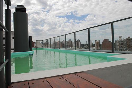 a swimming pool on the roof of a building at Espacio C Ambrosio Olmos in Cordoba