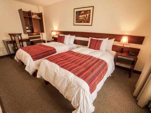 a hotel room with two beds in a room at Las Torres de Ugarte in Arequipa
