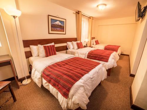 a hotel room with two beds in a room at Las Torres de Ugarte in Arequipa