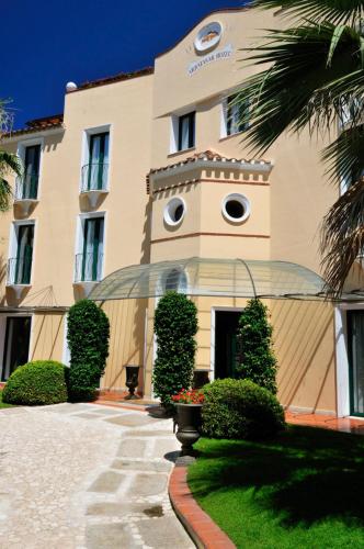 a large building with a palm tree in front of it at Hotel Arbatasar in Àrbatax