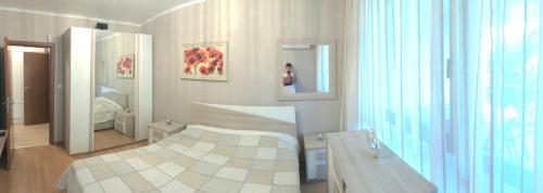 a rendering of a bedroom with a bed and a mirror at Vigo Luxe Apartment in Nesebar