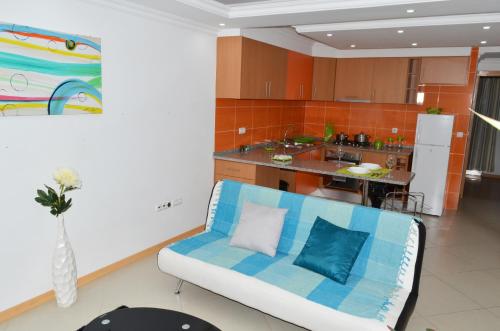 a living room with a couch and a kitchen at Dream Apartment in Praia