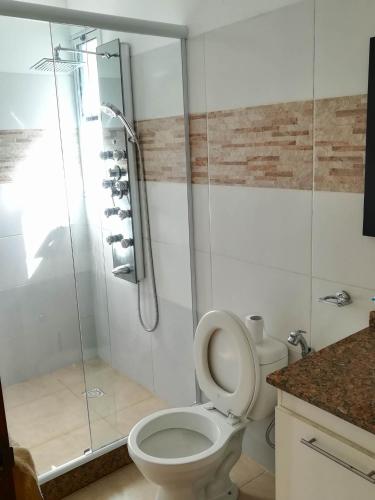 a bathroom with a toilet and a glass shower at las martinas apart 5 in Piriápolis
