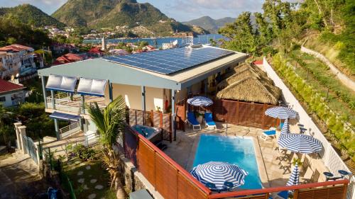 an aerial view of a house with solar panels on the roof at Residence Hôteliere Hurlevent in Grande Anse
